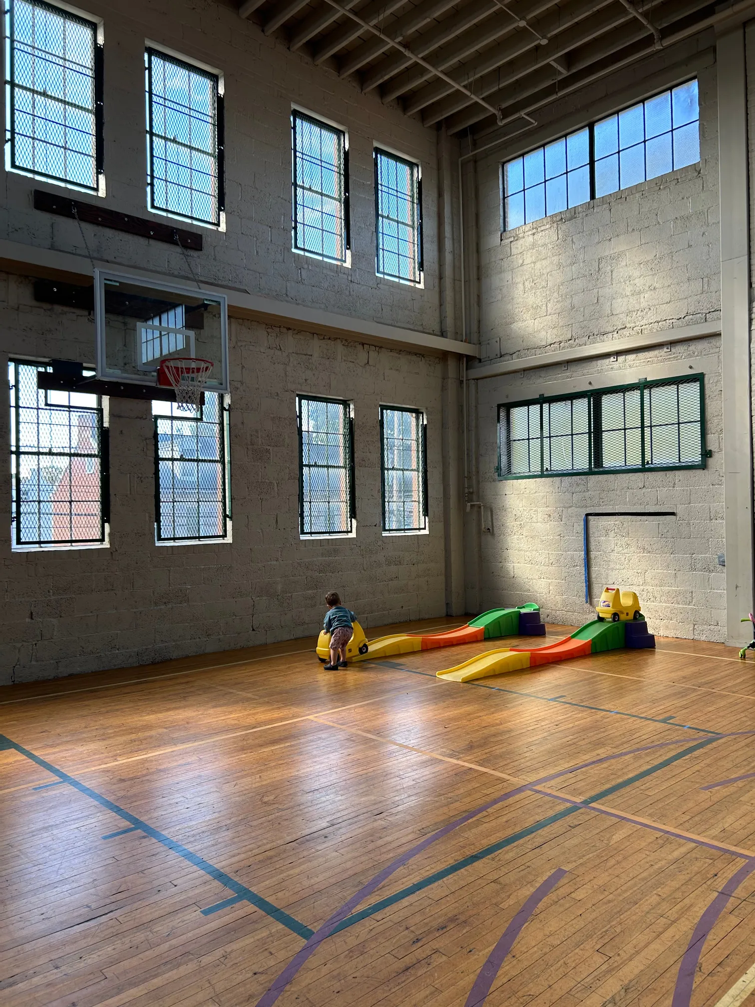 Tot Spot gymnasium featuring a pair of ride-on roller coaster toys